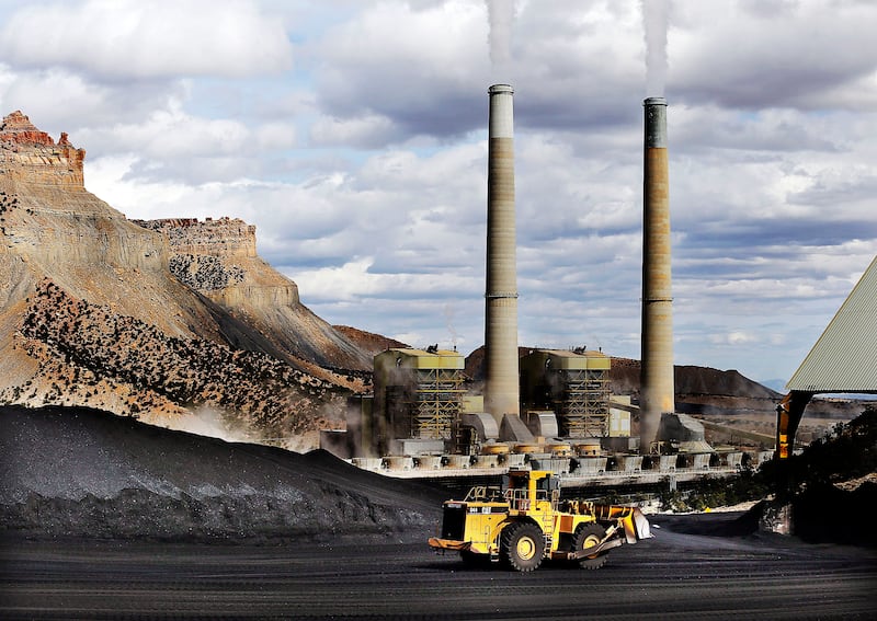 A loader moves coal at the Huntington power plant in Huntington, Tuesday, March 24, 2015.