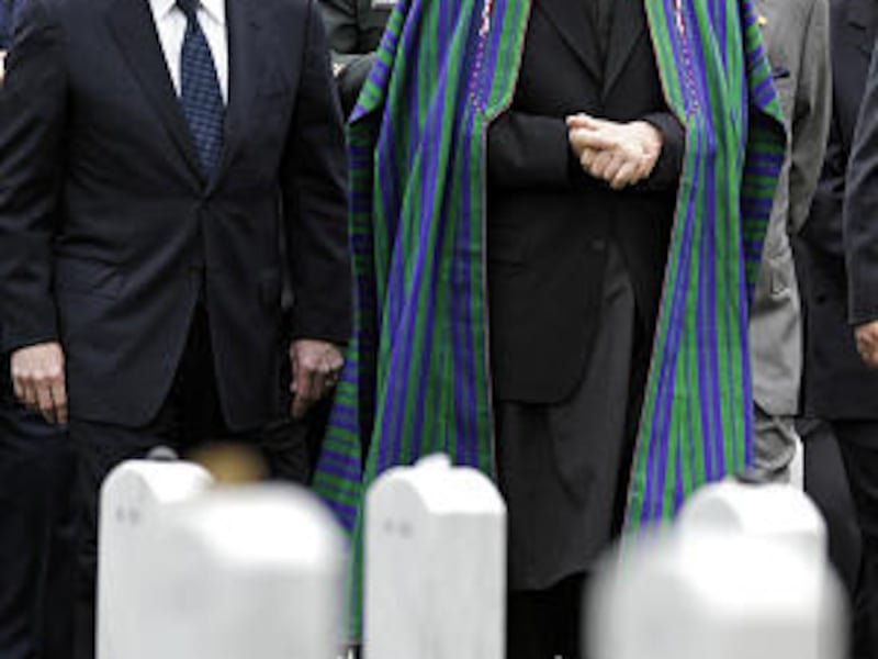 Afghan President Hamid Karzai, right, tours Arlington National Cemetery in Washington with Secretary of Defense William Gates, left, and Army Gen. Stanley McChrystal, commander of U.S. forces in Afghanistan, earlier this month.