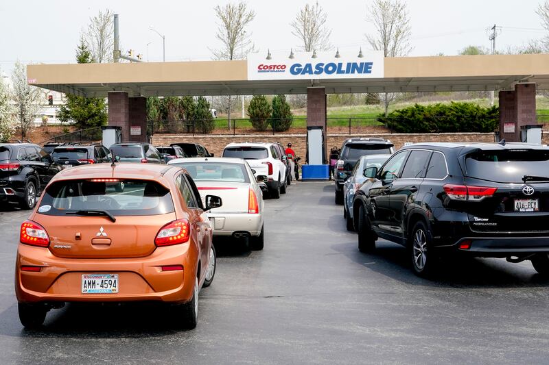 Cars line up for gas outside a Costco Wednesday, May 11, 2022, in Pewaukee, Wis.