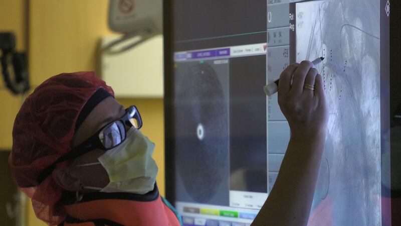 A medical professional in the operating room during a new aortic procedure.