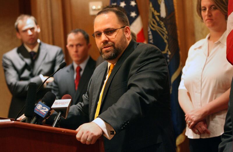 Rick Koerber holds a press conference at the Grand America in Salt Lake City in response to being charged earlier this week with running a massive Ponzi scheme, on Friday, May 29, 2009. Koerber plans to file a federal civil-rights violation lawsuit against several Utah employees. Behind him, from left, are business partners Steve Freestone and Sonny Jensen, and Koerber’s wife Michelle.