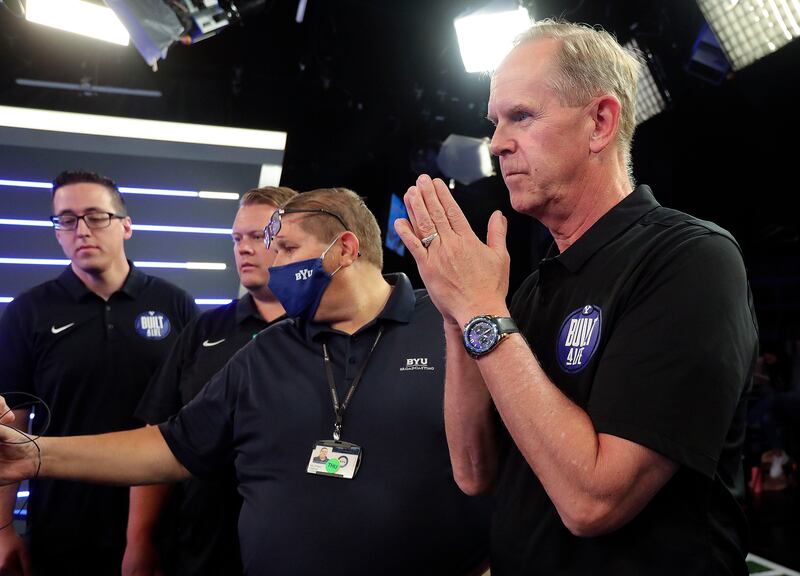 BYU athletic director Tom Holmoe watches an interview wrap up during BYU football media day at the BYU Broadcasting Building.