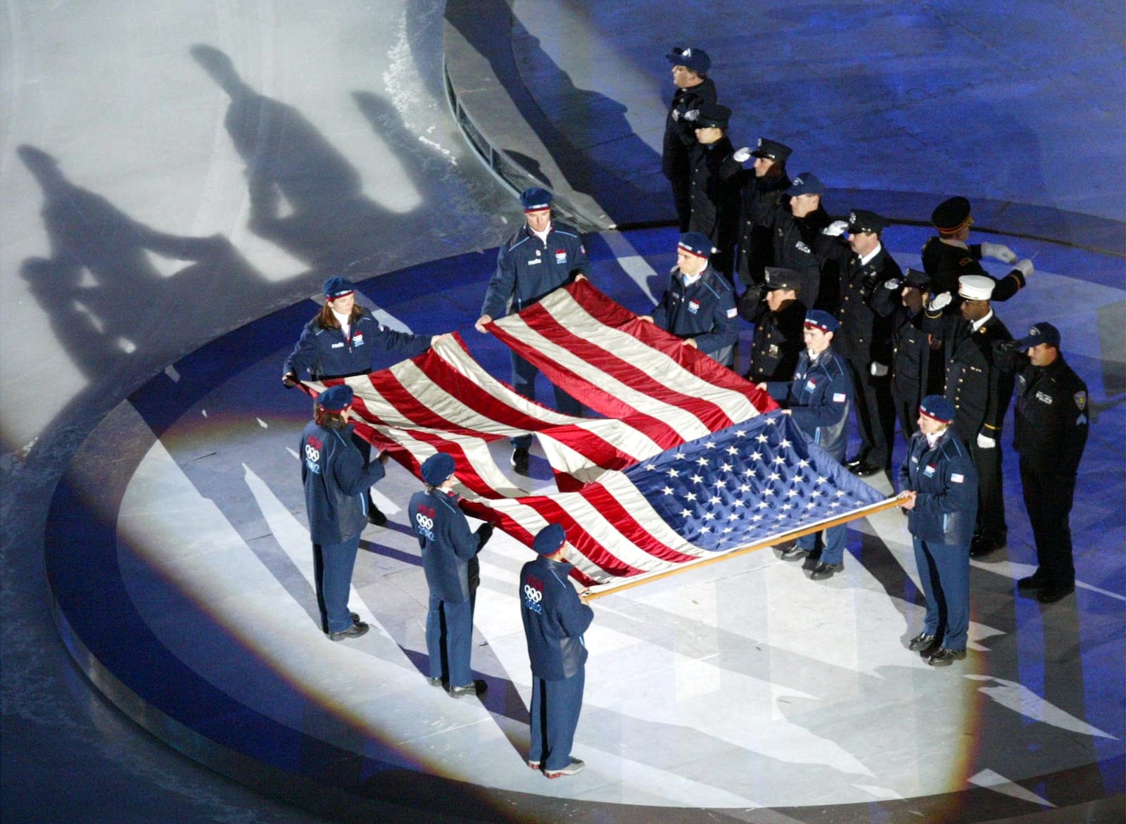 The World Trade Center flag is presented by U.S. athletes and members of the New York Police and Fire departments at the 2002 Winter Games.