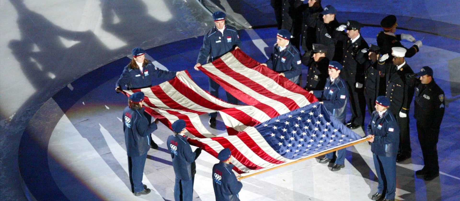 The World Trade Center flag is presented by U.S. athletes and members of the New York Police and Fire departments at the 2002 Winter Games.