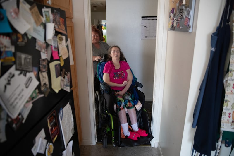 Kira Volar cares for her sister Tara, Saturday, August 4, 2018, in their home outside Sacramento, Calif. Kira is a 47-year-old full-time caregiver to her sister, who is paralyzed and has an intellectual disability. Kira has made caregiving her life's miss