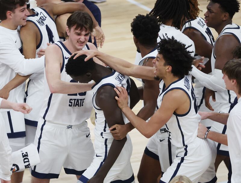 Utah State Aggies celebrate the win over the San Francisco Dons at the Delta Center in Salt Lake City on Saturday, Dec. 16, 2023. USU won 54-53.