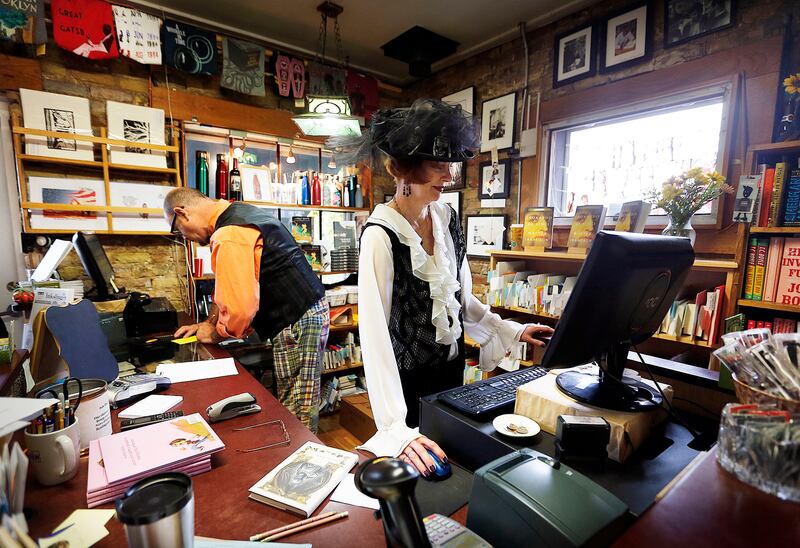Anne Stewart Mark and Rob Eckman help customers at the front desk during The History of Magic launch at The King's English Bookshop in Salt Lake City on Friday, Oct. 20, 2017. Some in the Utah community attribute the rise in popularity of young adult fict
