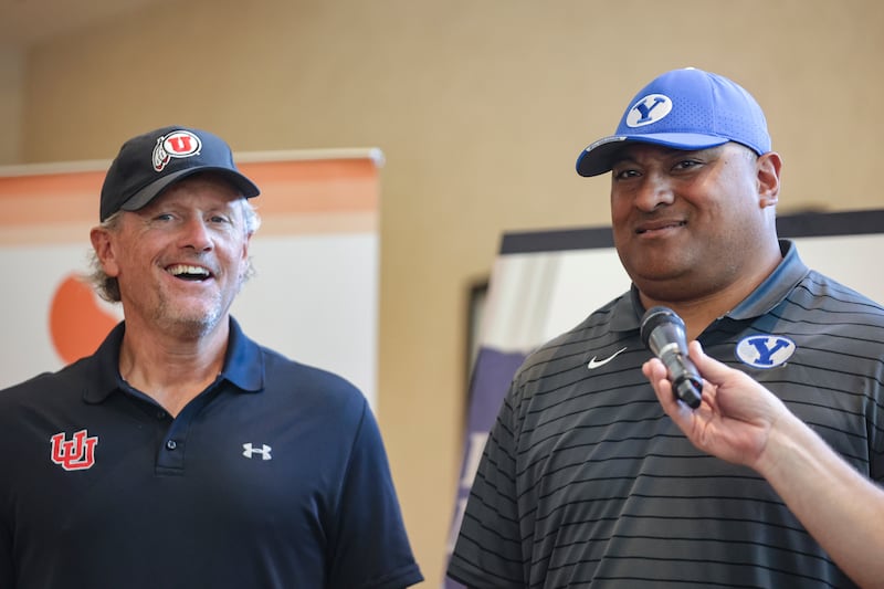 Utah football head coach Kyle Whittingham and BYU football head coach Kalani Sitake react to a question.