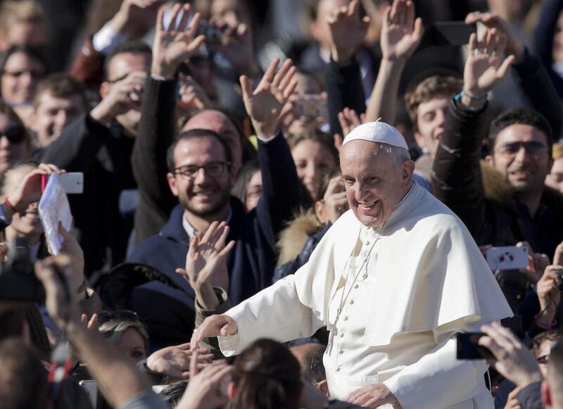 Pope Francis greets the crowd as he leaves St. Peter's Square at the Vatican, Friday, Feb. 14, 2014. Pope Francis met a group of engaged couples on Valentine's Day and gave them advice for a successful marriage.