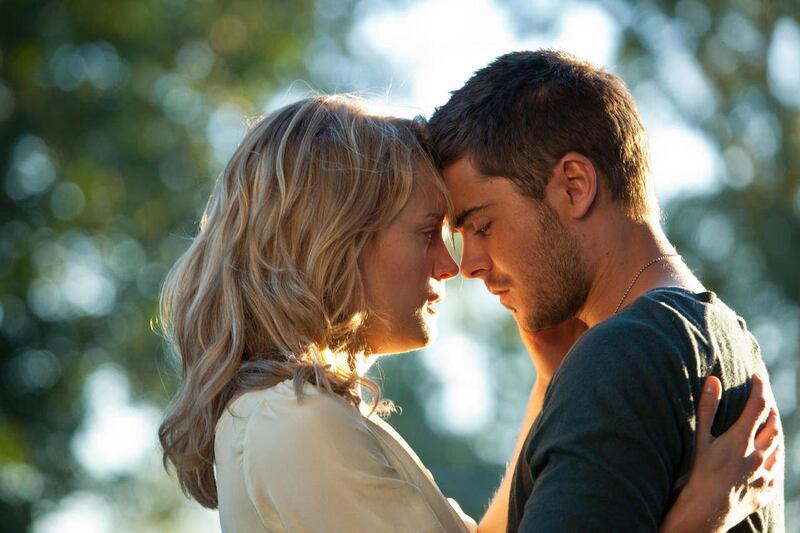 In this film image released by Warner Bros, Taylor Schilling, left, and Zac Efron are shown in a scene from "The Lucky One."