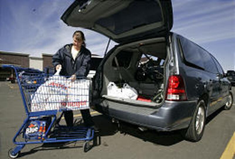 Jennifer Dionisio loads groceries into her 2004 Ford Freestar minivan in Warren, Mich. She said she likes the minivan because it's easy to load her three children. "I am who I am no matter what I drive," she said, adding that she wouldn't consider anythin
