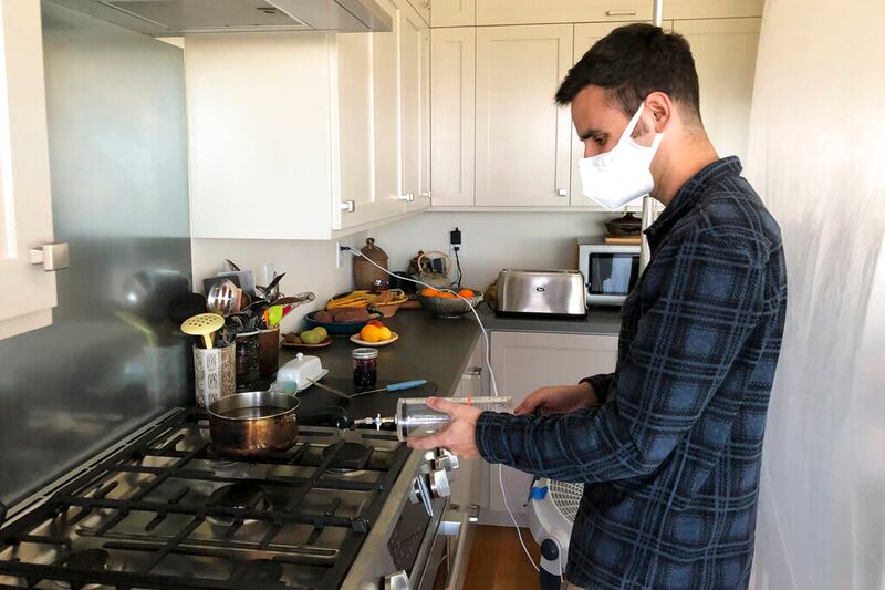researcher Colin Finnegan injects an ethane tracer to measure kitchen chamber volume.