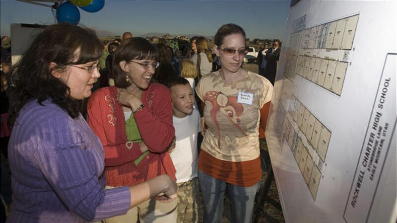 Julie Bell, left, Julie Anne Wankier, Jamin Wankier and Brenda Park inspect plans for Rockwell Public Charter High School on Wednesday.