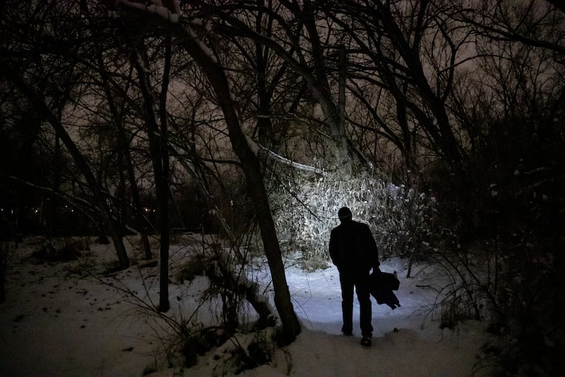 Shawn Spalding, an outreach worker for Volunteers of America - Utah, walks near the Jordan River while doing the annual Point-in-Time count in South Salt Lake on Thursday, Jan. 24, 2019.