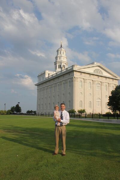 Scott Esplin holding one of his daughter in front of the Nauvoo, Illinois, temple of The Church of Jesus Christ of Latter-day Saints. His new book, "Return to the City of Joseph," is a social history of Nauvoo.