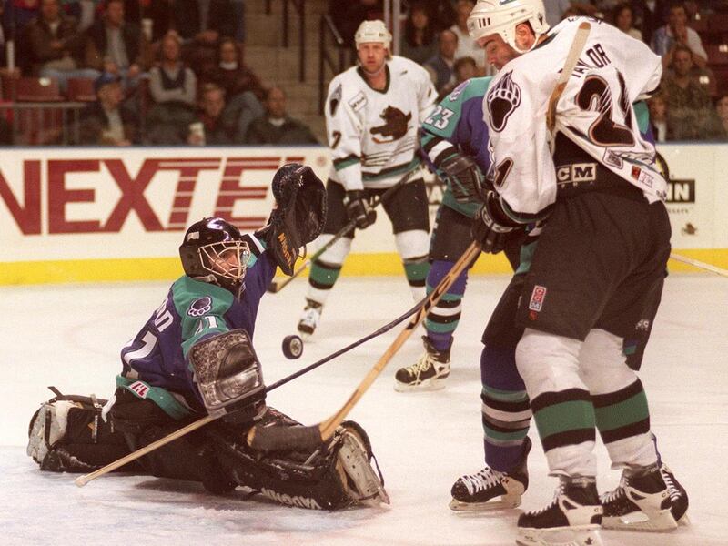 Orlando Solar Bears goalie David Littman stops Utah Grizzlies Chris Taylor from scoring in the second period at the E Center. Two years earlier, the Grizzlies defeated Orlando to win the Turner Cup.