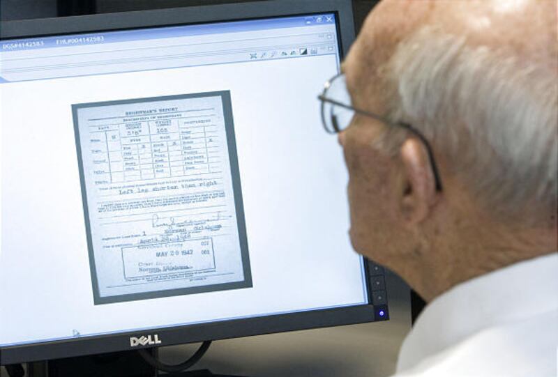 Elder Farr, of Tempe, Ariz., checks World War II draft records from Boise City, Okla., at the LDS Church's FamilySearch headquarters in Salt Lake City.