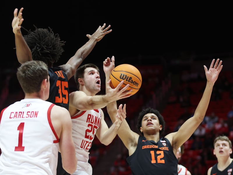 Utah guard Rollie Worster drives on Oregon State Beavers forward Michael Rataj (12) in Salt Lake City on Jan. 5, 2023.