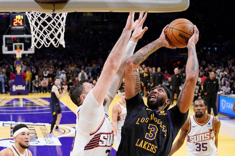 Los Angeles Lakers forward Anthony Davis (3) shoots as Phoenix Suns center Jusuf Nurkic defends during an NBA basketball In-Season Tournament quarterfinal game Tuesday, Dec. 5, 2023.