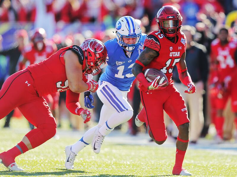 Utah defensive back Dominique Hatfield returns an interception for a TD as Utah and BYU play in Las Vegas Bowl in 2015.