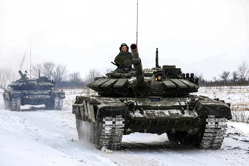 Russian tanks roll on the field during a military drills in Leningrad region, Russia.