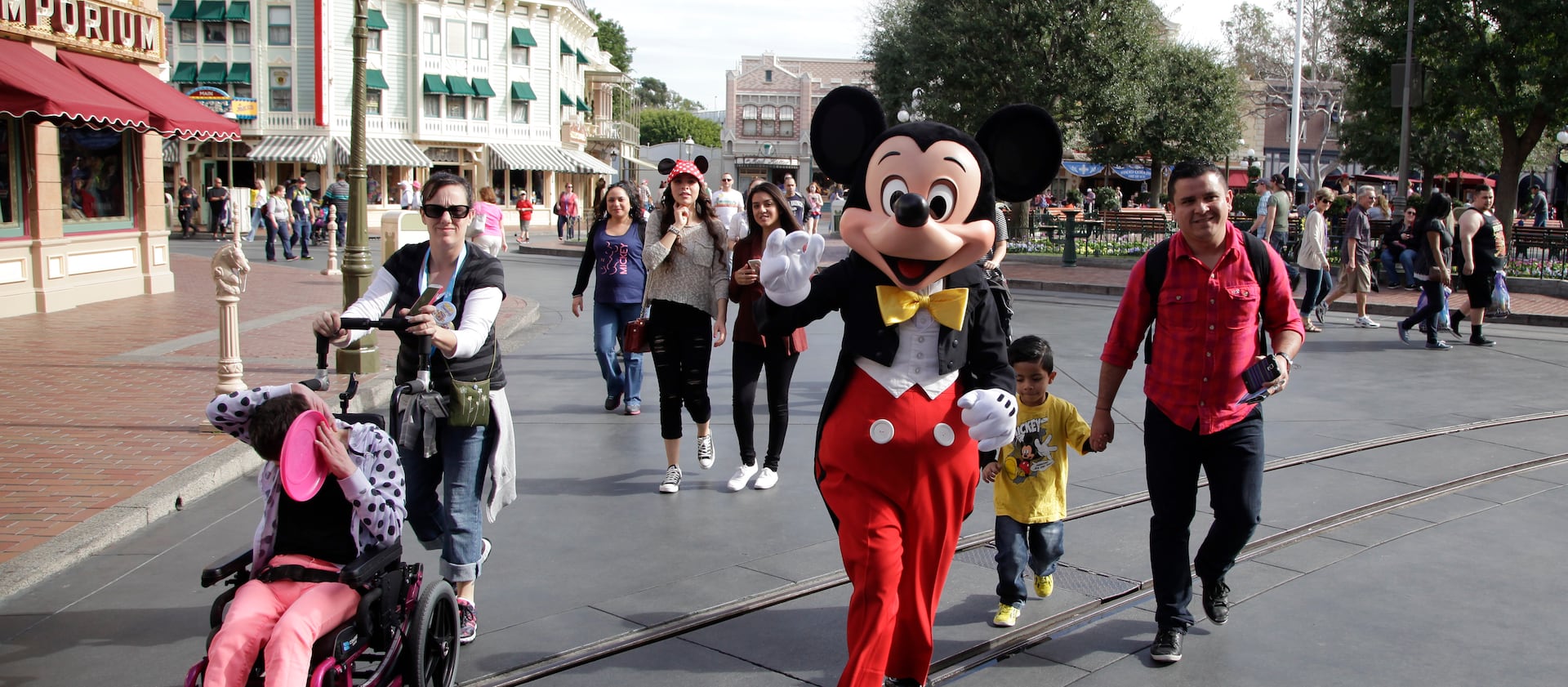 Mickey Mouse walks with families at Disneyland on in Anaheim, California, in January 2015.