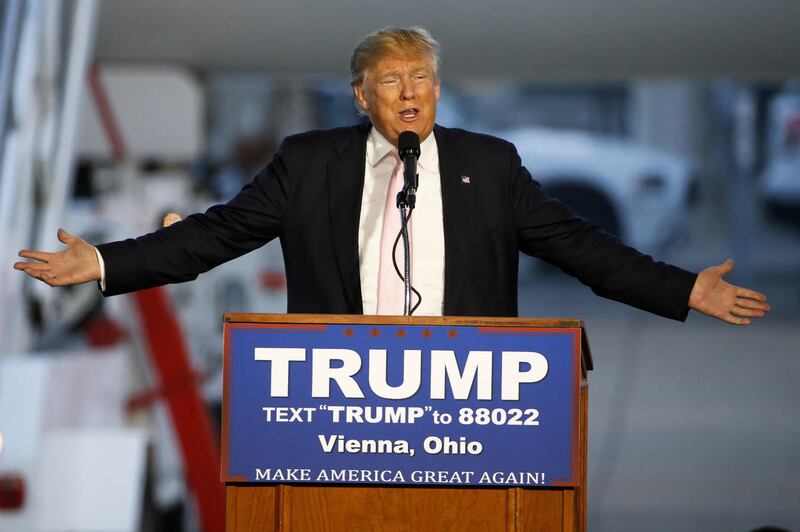 Republican presidential candidate, Donald Trump holds a plane-side rally in a hanger at Youngstown-Warren Regional Airport in Vienna, Ohio, Monday, March 14, 2016.  (AP Photo/Gene J. Puskar)
