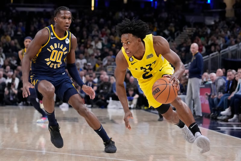 Utah Jazz guard Collin Sexton (2) drives around Indiana Pacers guard Bennedict Mathurin (00) during the second half of an NBA basketball game in Indianapolis, Monday, Feb. 13, 2023. The Jazz defeated the Pacers 123-117. (AP Photo/Michael Conroy)