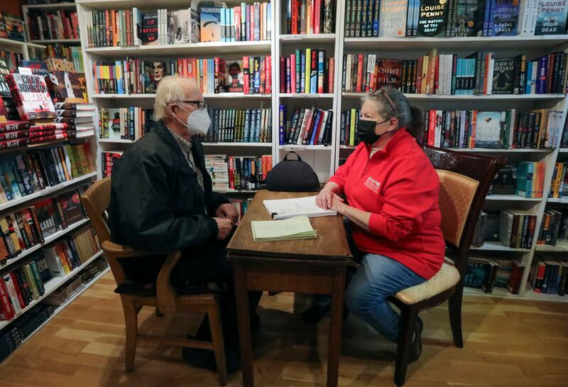 Local author Tim Larson, left, shows a manuscript to Anne Holman, co-owner of The King’s English Bookshop, for potential publication through TKE Ink, at The King’s English Bookshop in Salt Lake City on Wednesday. Salt Lake City Mayor Erin Mendenhall announced the Shop Small Crawl to support Small Business Saturday, including the chance to win a $500 local shopping spree.
