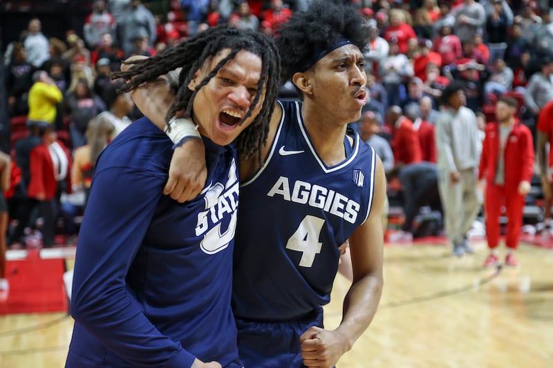 Utah State guards Garrison Phelps (2) and Ian Martinez (4) react after their 87-86 win against UNLV on Jan. 13, 2024.