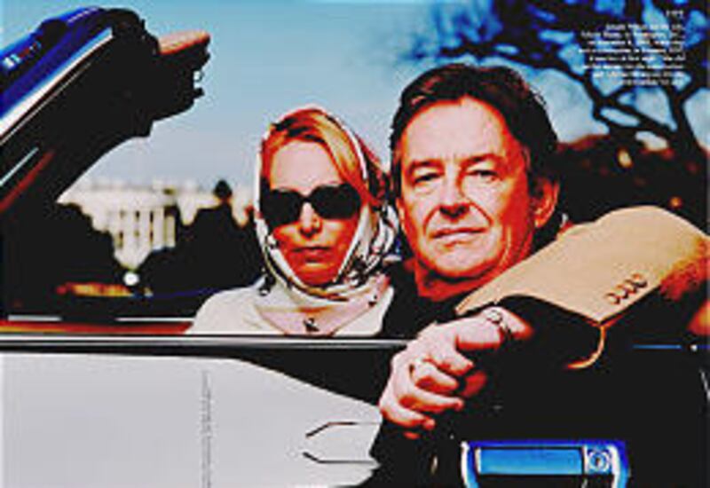 Valerie Plame, left, and her husband, Joseph C. Wilson, sit in their convertible near the White House on Nov. 18, 2003. A news leak has ruined her career as a CIA agent.