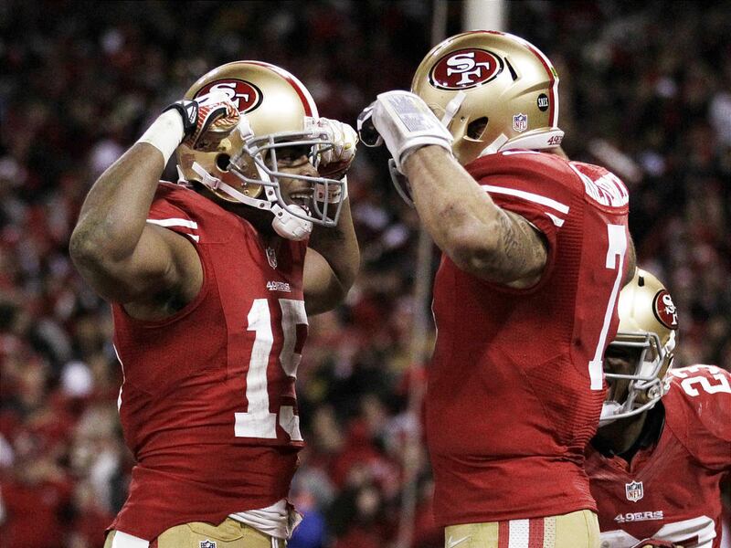 San Francisco’s Michael Crabtree (15) and Colin Kaepernick (7) celebrate after Kaepernick’s 56-yard TD run.