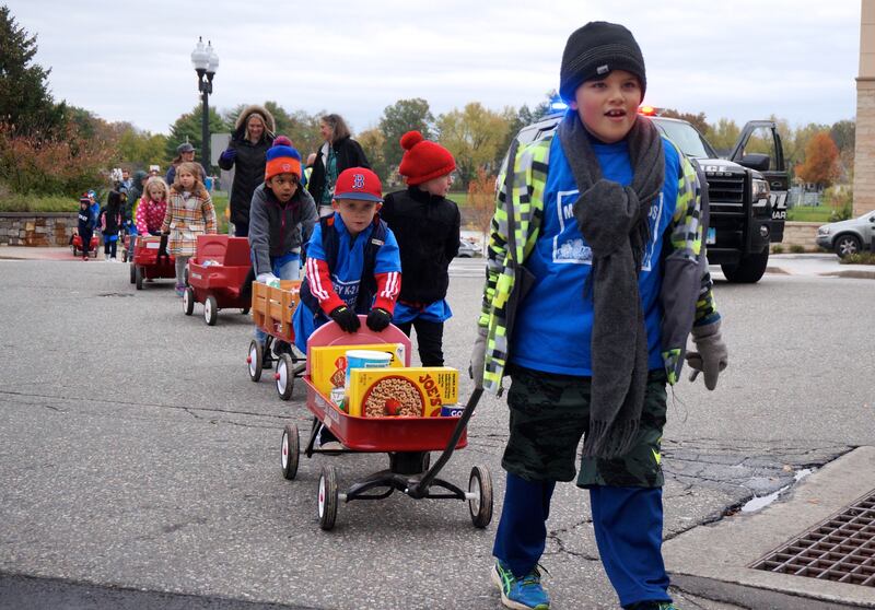 Children from Morley Elementary School in West Hartford, Connecticut, walked more than a mile pulling donations for a food bank on wagons in November 2017. Hands-on service helps to build character in children, child-development experts say.