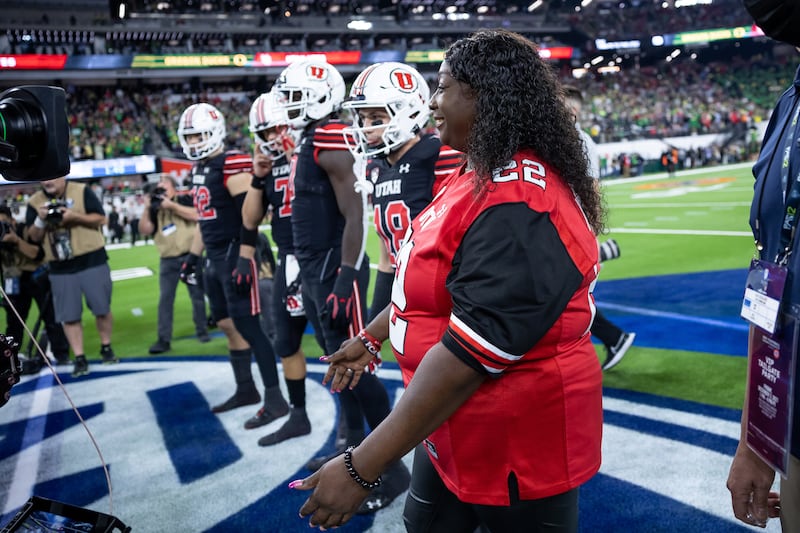 Donna Lowe-Sterns, mother of the late Utah player Aaron Lowe, serves as honorary captain at Pac-12 championship game.