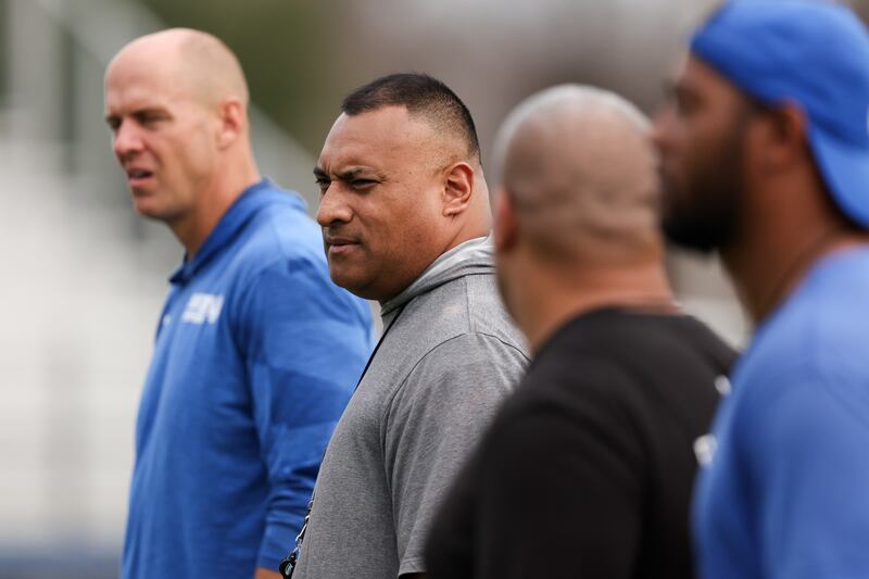 BYU coach Kalani Sitake along with members of his staff look on during preparations for the Independence Bowl.