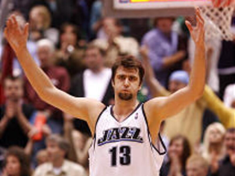 On a night when he would have rather been home in bed, Mehmet Okur, who was sick but still scored 29, celebrates the Jazz's win.