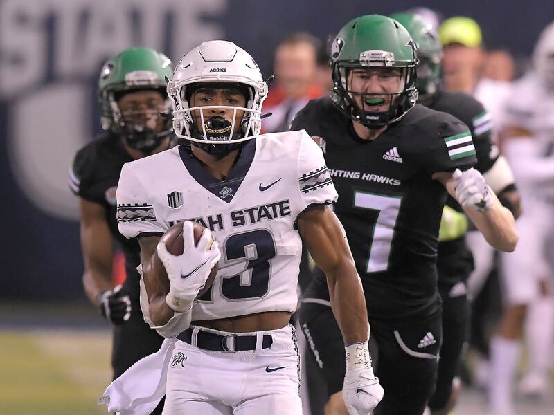 Utah State wide receiver Deven Thompkins runs down the field for a 75-yard touchdown.