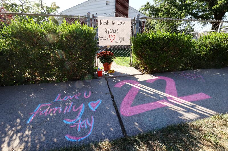A memorial for University of Utah sophomore defensive back Aaron Lowe, with “22” written on the sidewalk in chalk