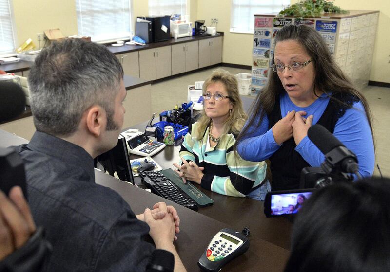 Rowan County Clerk Kim Davis, right, talks with David Moore following her office's refusal to issue marriage licenses at the Rowan County Courthouse in Morehead, Ky., Tuesday, Sept. 1, 2015. Although her appeal to the U.S. Supreme Court was denied, Davis