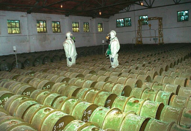 Two Russian soldiers make a routine check of metal containers with toxic agents at a chemical weapons storage site in 2000.