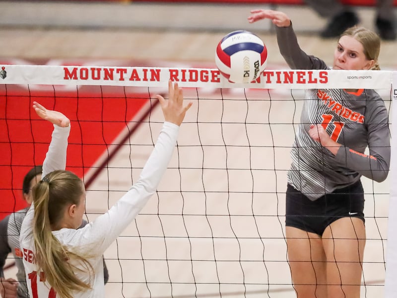 A Skyridge player hits the ball over the net