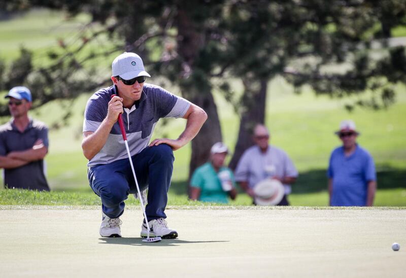 Eddie Olson eyes up his putt on the 18th green of the Siegfried & Jensen Utah Open in Provo Sunday. Olson finished fifth with 14 under par.