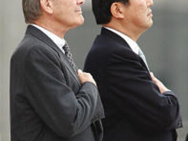 Defense Secretary Donald H. Rumsfeld, left, and his Japanese counterpart, Shigeru Ishiba, attend the guard of honor.