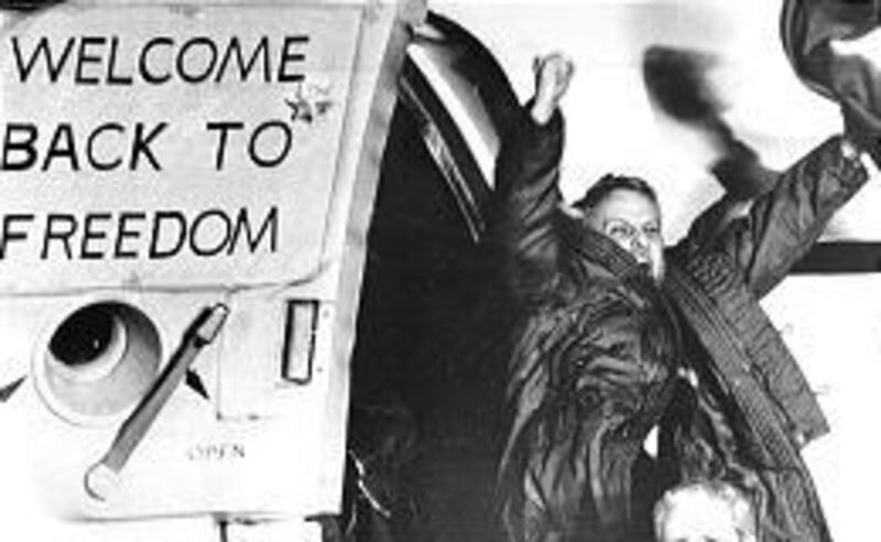 Former hostage in Iran David Roeder shouts and waves as he arrives at Rhein-Main U.S. Air Force base near Frankfurt, West Germany, Jan. 21, 1981, after being held with 51 other kidnapped hostages for 444 days.