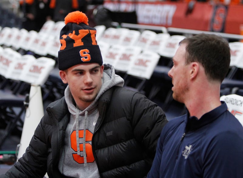 Syracuse guard Joe Girard III, left, talks with Syracuse assistant coach Gerry McNamara, right, before a game against Duke.