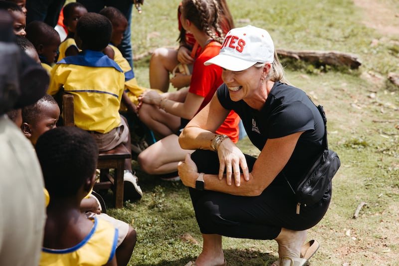 University of Utah gymnasts coach Carly Dockendorf visits with a young student during Engage Now Africa Education Day in Ghana earlier this this month.