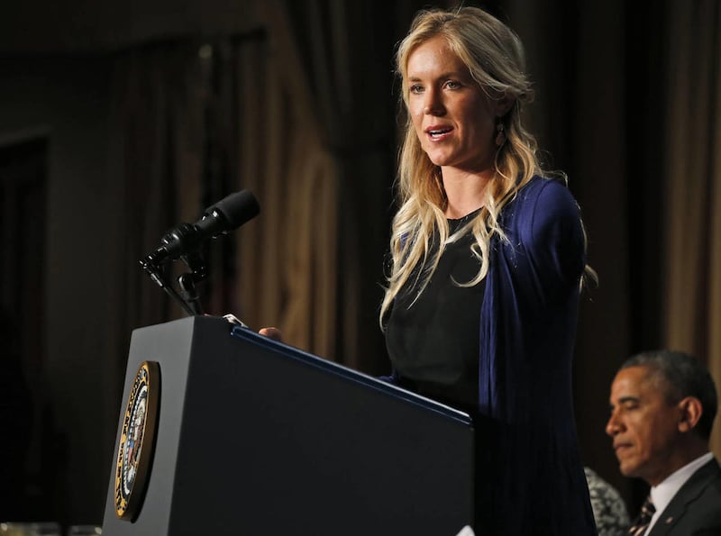 Surfer Bethany Hamilton Dirks, who lost her left arm in a shark attack while surfing in Hawaii, speaks as President Barack Obama listens at the National Prayer Breakfast in Washington, Thursday, Feb. 6, 2014.