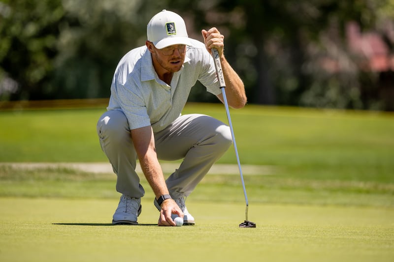Mitchell Schow lines up his putt during the Utah Championship, part of the PGA Korn Ferry Tour, at Oakridge Country Club in Farmington on Saturday, Aug. 5, 2023.