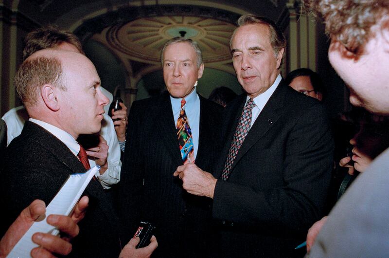 Senate Majority Leader Bob Dole, of Kansas, right, and Sen. Orrin Hatch, R-Utah, meet reporters in 1995.