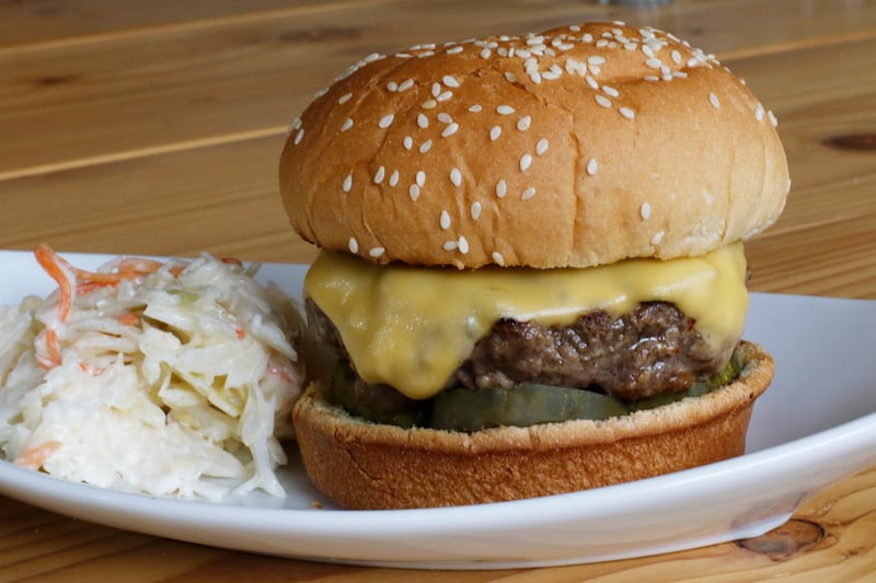This April 2016 photo shows a grilled cheeseburger next to some coleslaw